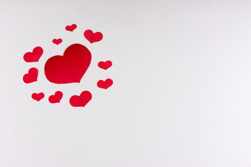 Red hearts on a white background. Love card concept with copy space, Valentine's day theme. Shot from above