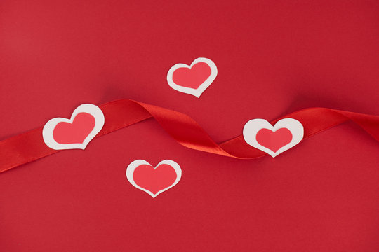 Paper hearts and red ribbon on red background, Love card concept , Valentine's day theme