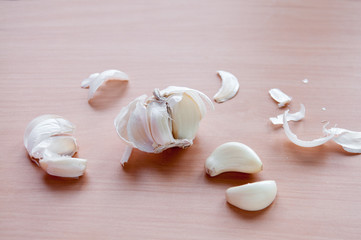 Purified head of garlic on a brown table