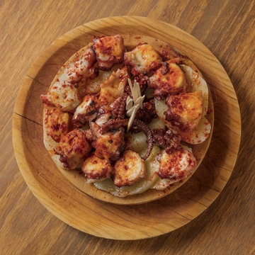 Photo of octopus with fried potatoes, typical Spanish dish