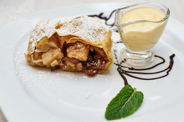 sweet strudel with pears and raisins in creamy sauce