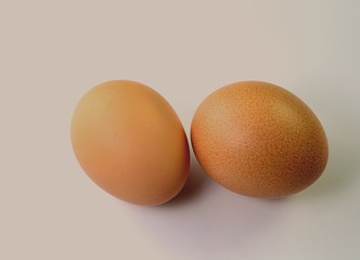 Two chicken eggs on a white background for illustration and more