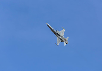 Fototapeta na wymiar military fighter jet aircraft flying blue sky background