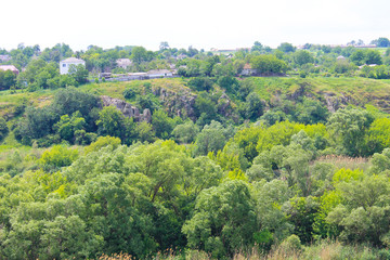 Obraz premium Summer landscape with trees, hills and rocks