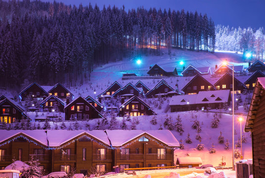 Fototapeta Christmas winter landscape, old wooden house, surrounded by snow-capped fir trees