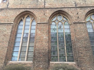 Church windows and brick block wall