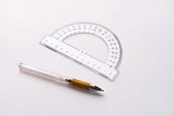 Pen and protractor on white background