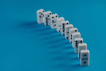 White domino play pieces on blue background