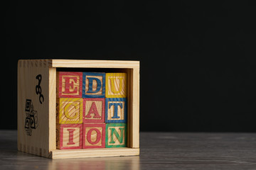 Education word on wooden cubes with letters in wooden box