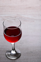 glass of red wine .glass of wine on a light wooden background