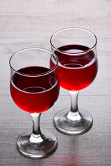 glass of red wine. A couple of glasses of wine on a light wooden background