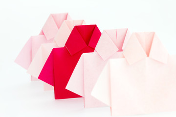 One Red among white origami shirt paper , unique individuality 