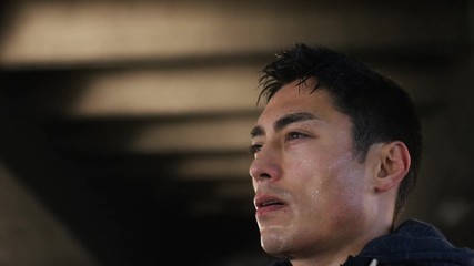 4K Young asian male athlete stands up after a workout to get his breath, in slow motion