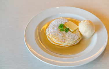 Pancake  with ice cream on table .