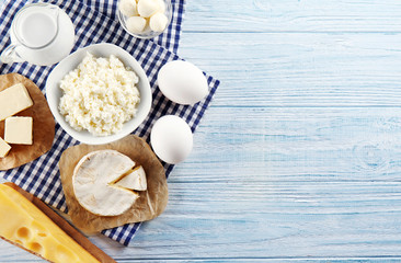 Dairy products on wooden background, top view
