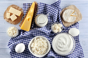 Dairy products on wooden background, top view