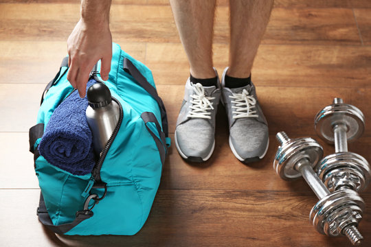 Male legs and sport bag on the floor