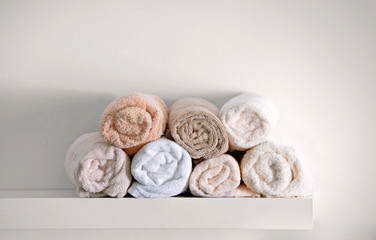 Stack of clean towels on shelf