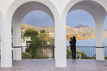 Woman taking pictures with tablet at Balcony Of Europe