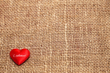 Red heart on a background of burlap