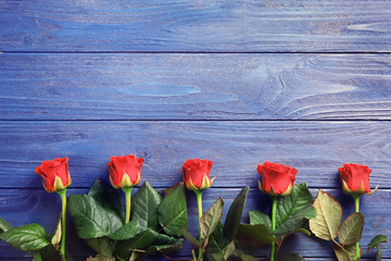 Fototapeta na wymiar Bouquet of beautiful red roses on wooden background