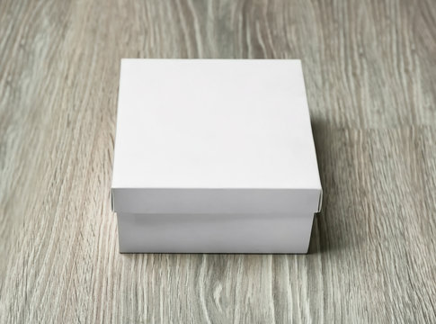 White cardboard box on wooden background