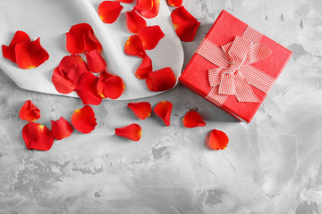St. Valentines Day concept. Gift box and petals on table