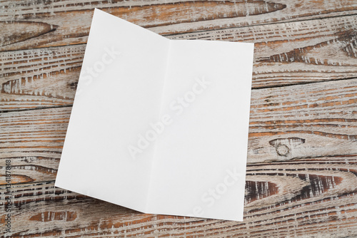 bifold white template paper on wood texture fotolia com の