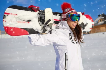 Wall murals Winter sports Sport woman  snowboarder on snow over blue sky