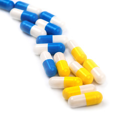 yellow and blue  pills on a white background