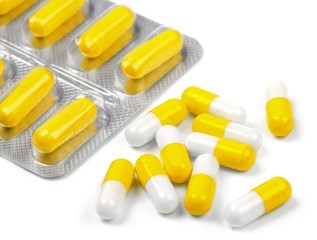 useful yellow pills on a white background