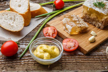 Homemade jelly meat with mustard, bread, tomatoes and garlic on the table. Holodets