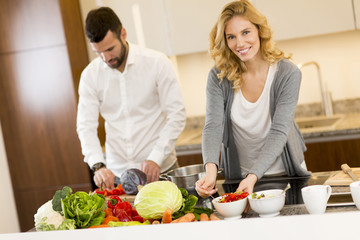 Young couple preparing meal in the kitchen