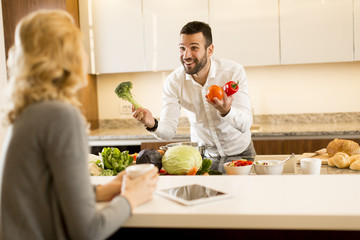 Young couple preparing meal in the kitchen
