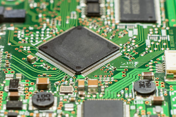 Close up of electronic circuit board with microchip and components