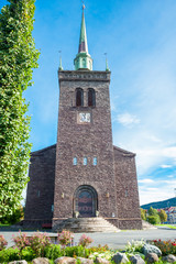 Fototapeta premium Front facade exterior of a small stone built Scandinavian church