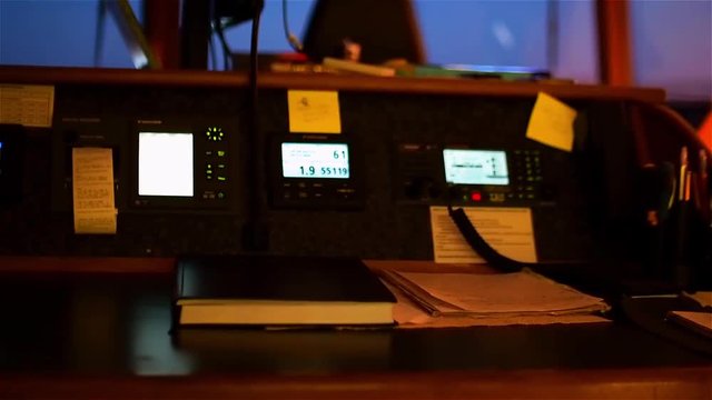 Instrument panel of ship in twilight, in lamplight. Close-up.