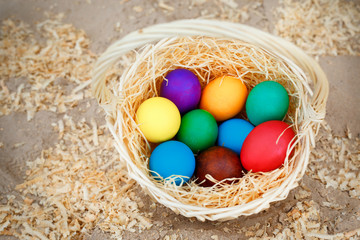 Fototapeta na wymiar Basket full of colorful eggs