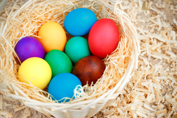 Fototapeta na wymiar Basket full of colorful eggs