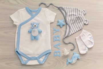bodysuit and pants newborn socks and a toy bear