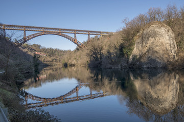 old iron bridge over Adda river at Paderno, Italy