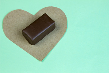 Candy cane on a piece of paper heart with a Cup of coffee on tur