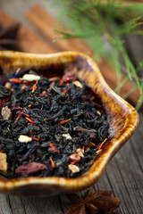 Dried winter tea with spices on wooden table