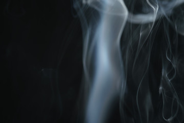 mystery light blue smoke over dark background with copy space, abstract photo