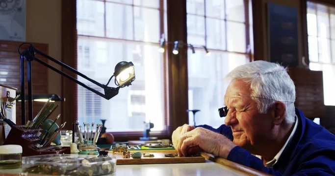 Horologist repairing a watch