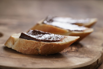 baguette slices with homemade hazelnut cream gianduja on cutting board