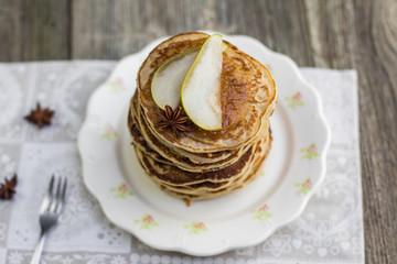 Top View on Whole grain pancakes with pear jam and star anise