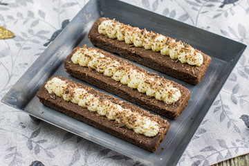 Detail on Small cocoa cakes with whipped buttercream on metal pl