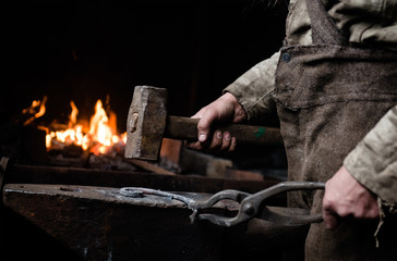 The hands of a blacksmith at work in the smithy