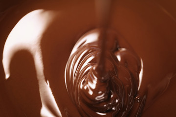 melted dark premium chocolate pour from above, slightly toned photo